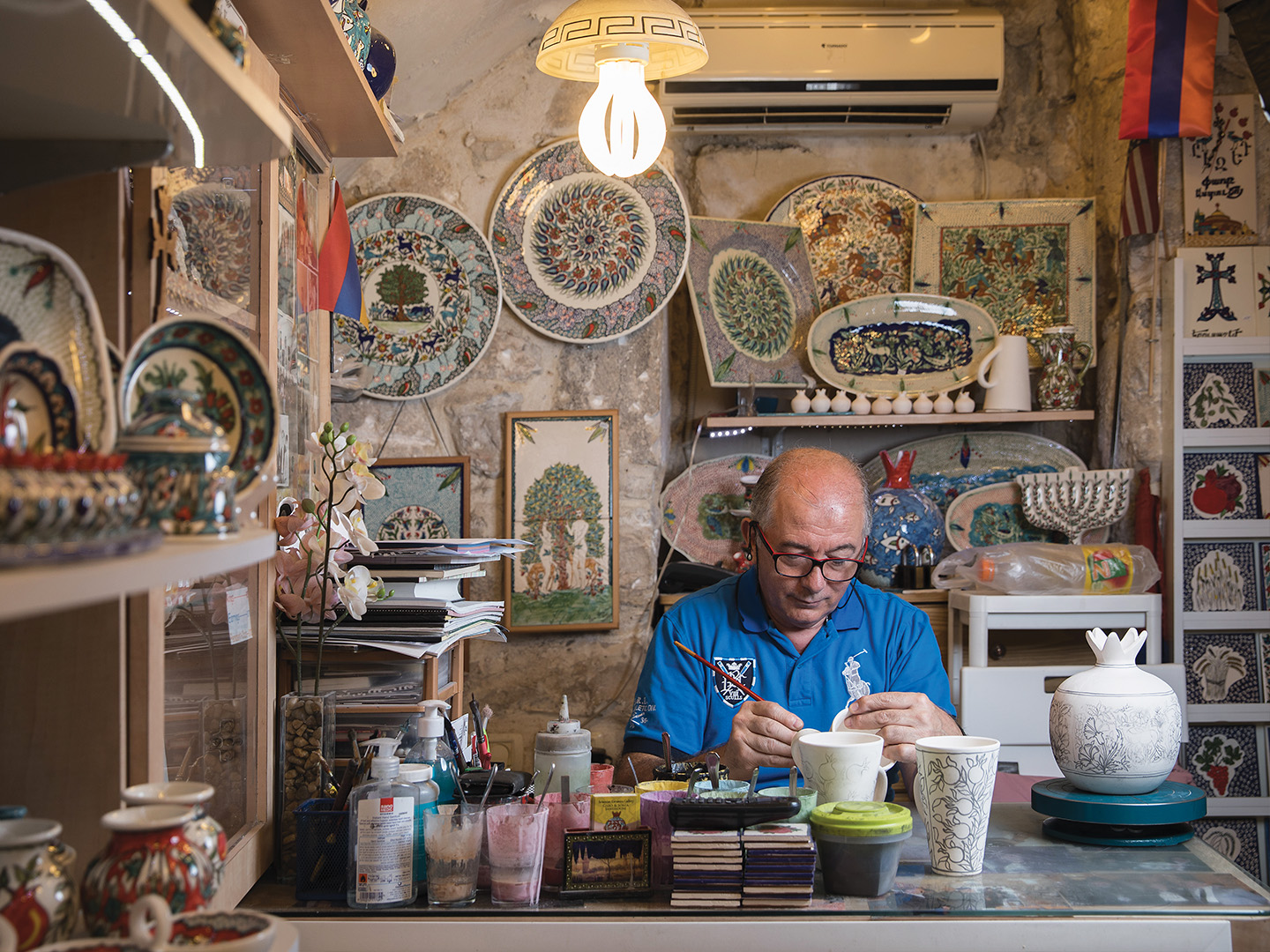 Ceramics artist Garo Sandrouni working in his shop in the Armenian Quarter. His two brothers, Harout and George, also have their own ceramic establishments.