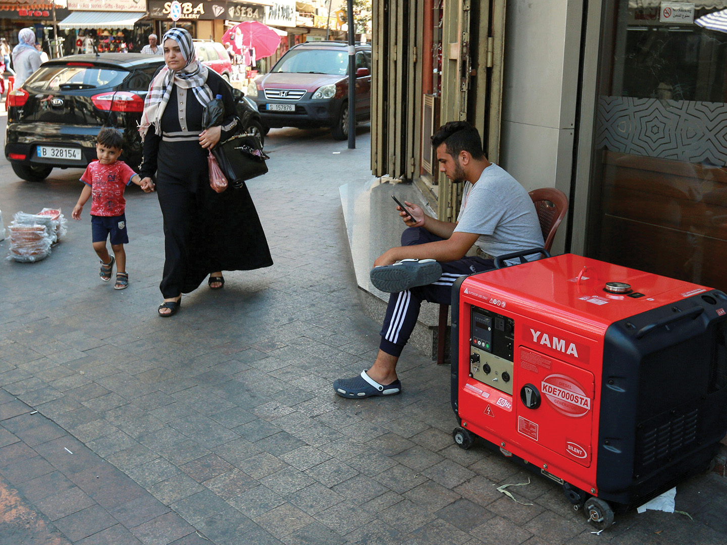 A business in Sidon, Lebanon uses a portable generator to compensate for the ongoing power outages, August 2021.