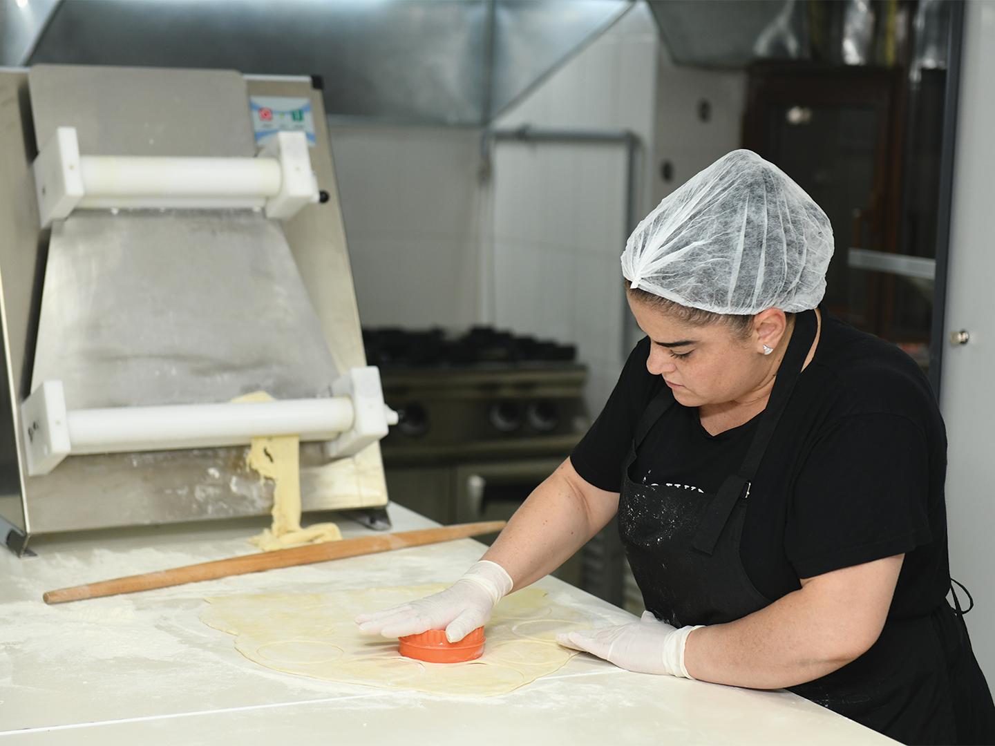 Vicky Tatoyan, a cook at the Aleppo Cuisine Center, at work preparing Samusak
