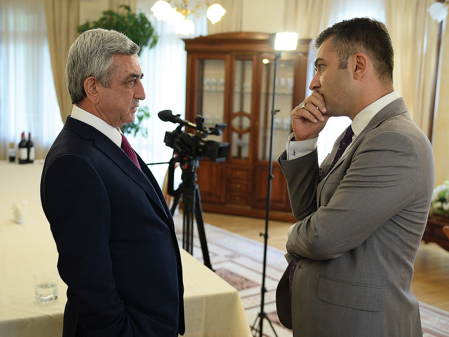 A reporter carefully listening to President of Armenia Serzh Sargsyan