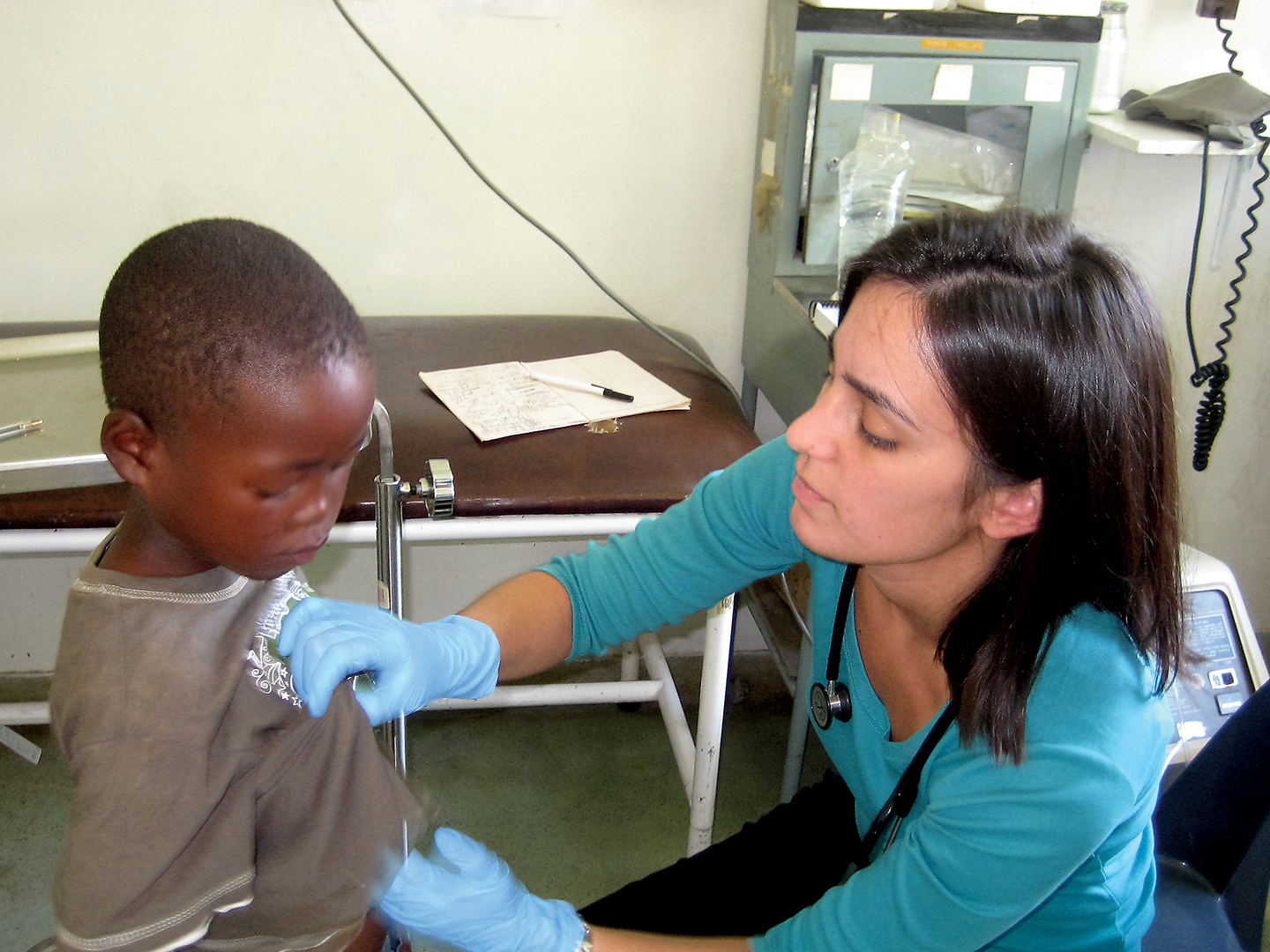 Young Doctor checking up an african kid.