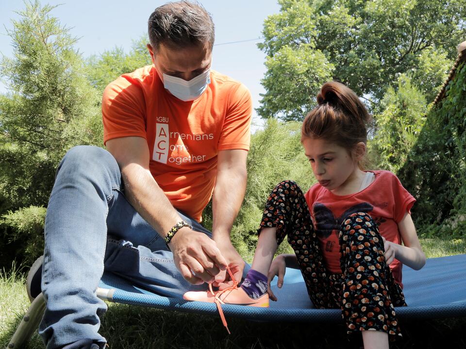 ACT volunteer working with a child