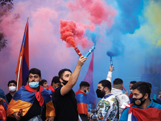 Protesters use flares at the Armenian colors during the march. Toulouse's Armenians staged a march for Armeniai and the Nagorno-Karabakh.