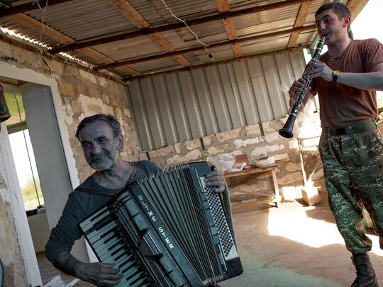 Gharib Marutyan, a 65-year-old historian and 1992-1994 Karabakh war veteran, has brought his accordion— which survived the previous war—to entertain sons of his former comrades.