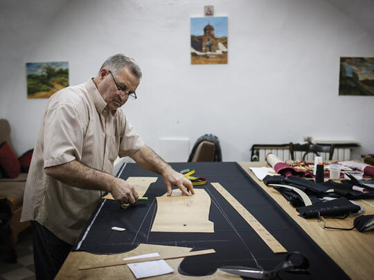 An Armenian tailor sews the black robes worn by Armenian priests in his workshop inside the convent.