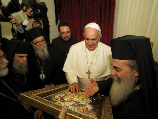 Greek Patriarch Theophilos III presents Pope Francis with a gift inside the Church of Bethphage, Mount of Olives.