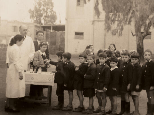 One of AGBU medical dispensaries distributes nutrient rich cod liver oil to students. 