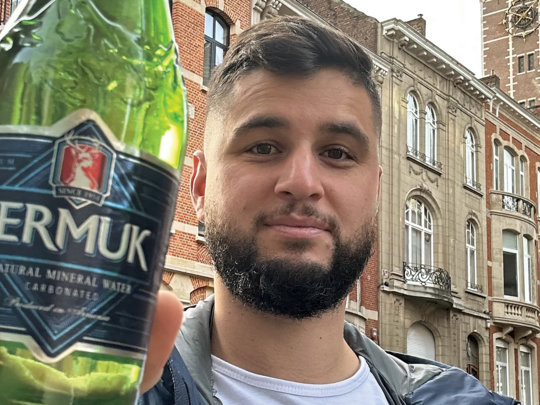 Rouben Koulaksezian shows off a bottle of Jermuk mineral water he found on his travels through Brussels. Photo Credit: Rouben Koulaksezian