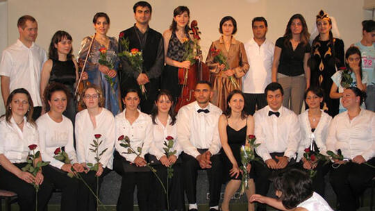 Armenian musicians, choir members, and dancers pose for a gr